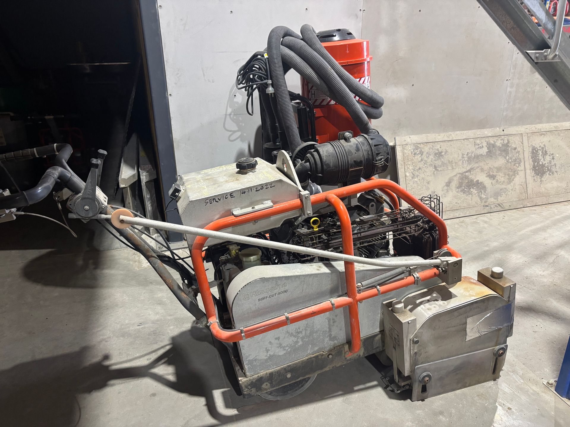 A Concrete Saw Is Cutting A Concrete Floor — Newcastle Cut & Drill In Boolaroo, NSW