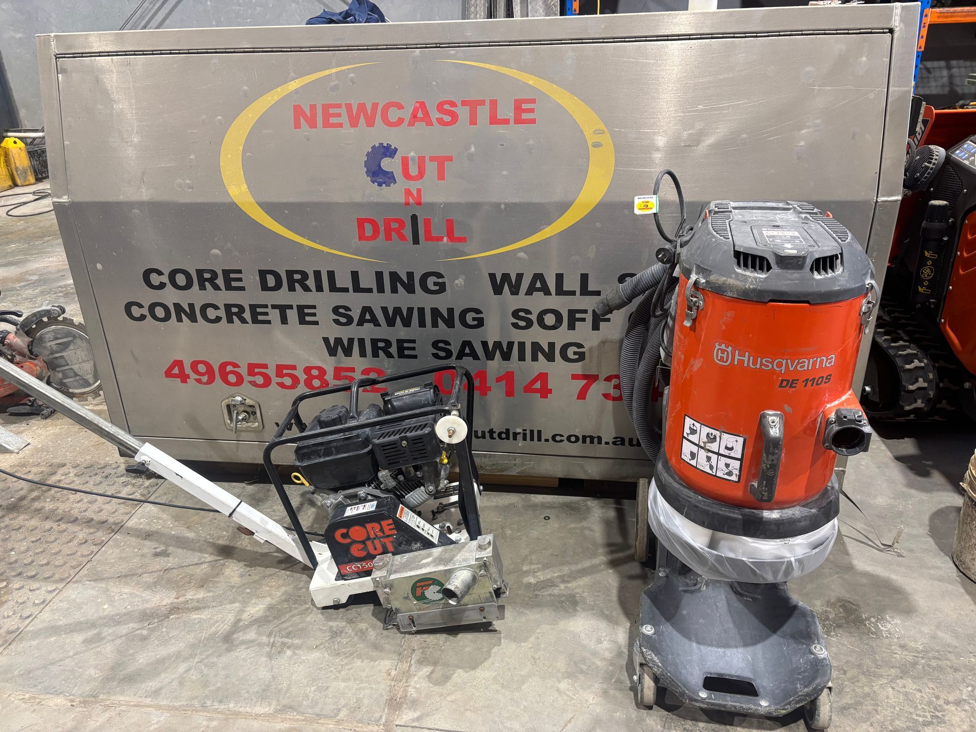 Small concrete cutters in front of a sign — Newcastle Cut & Drill In Boolaroo, NSW