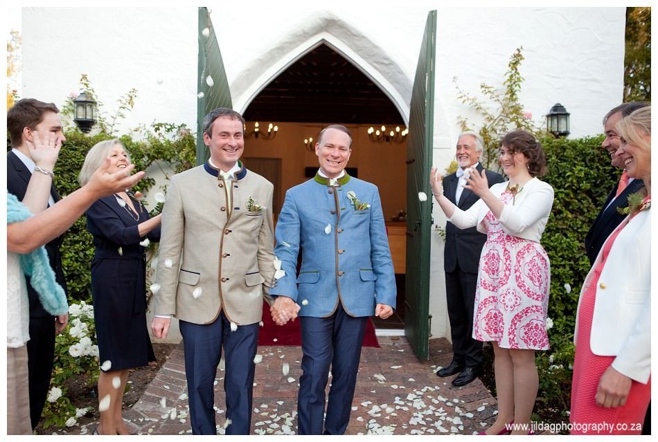 A group of people standing outside of a church holding hands