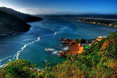 A large body of water surrounded by mountains and trees