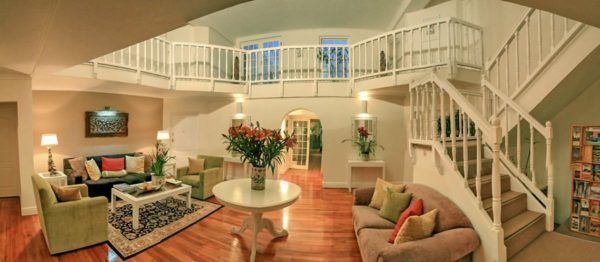 A living room with a staircase leading to the second floor