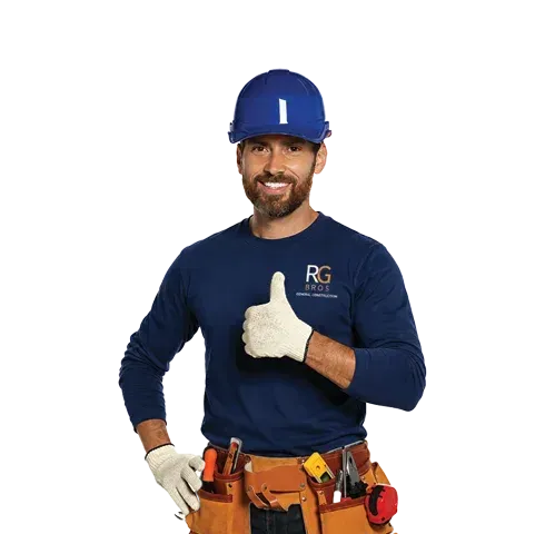 Construction worker in blue hard hat and shirt, wearing tool belt and giving a thumbs-up.