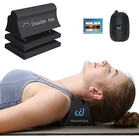 A woman is laying on a yoga mat with a pillow on her neck.