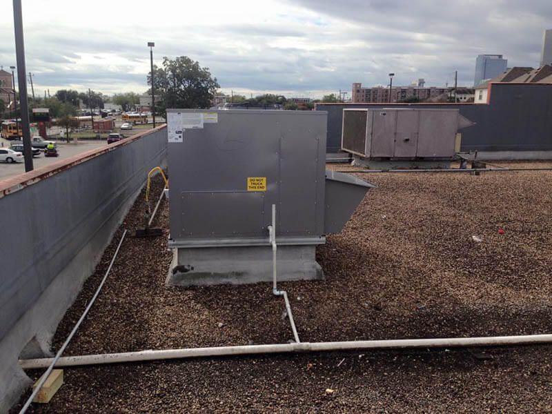 The roof of a building with a large box on top of it