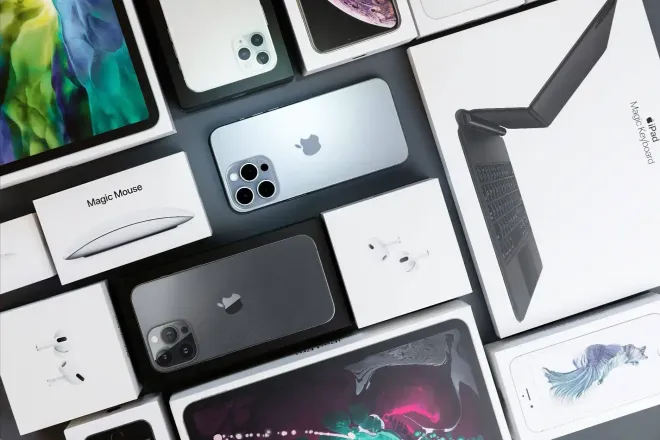 Assorted smartphones and gadgets arranged on a white background, including iPhones and accessories