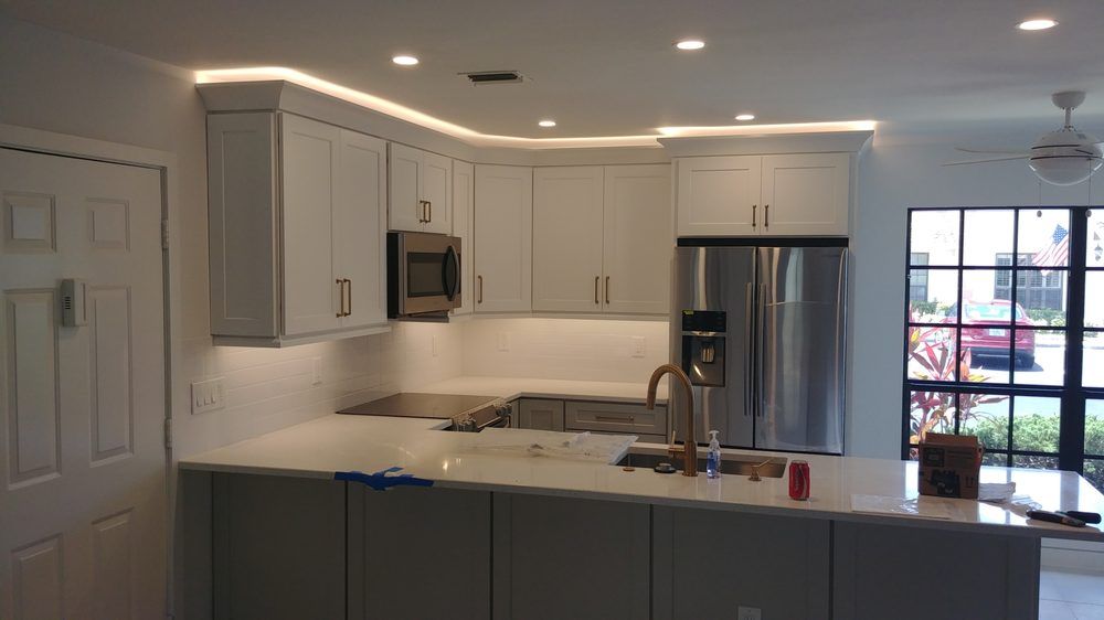 A kitchen with white cabinets and stainless steel appliances.