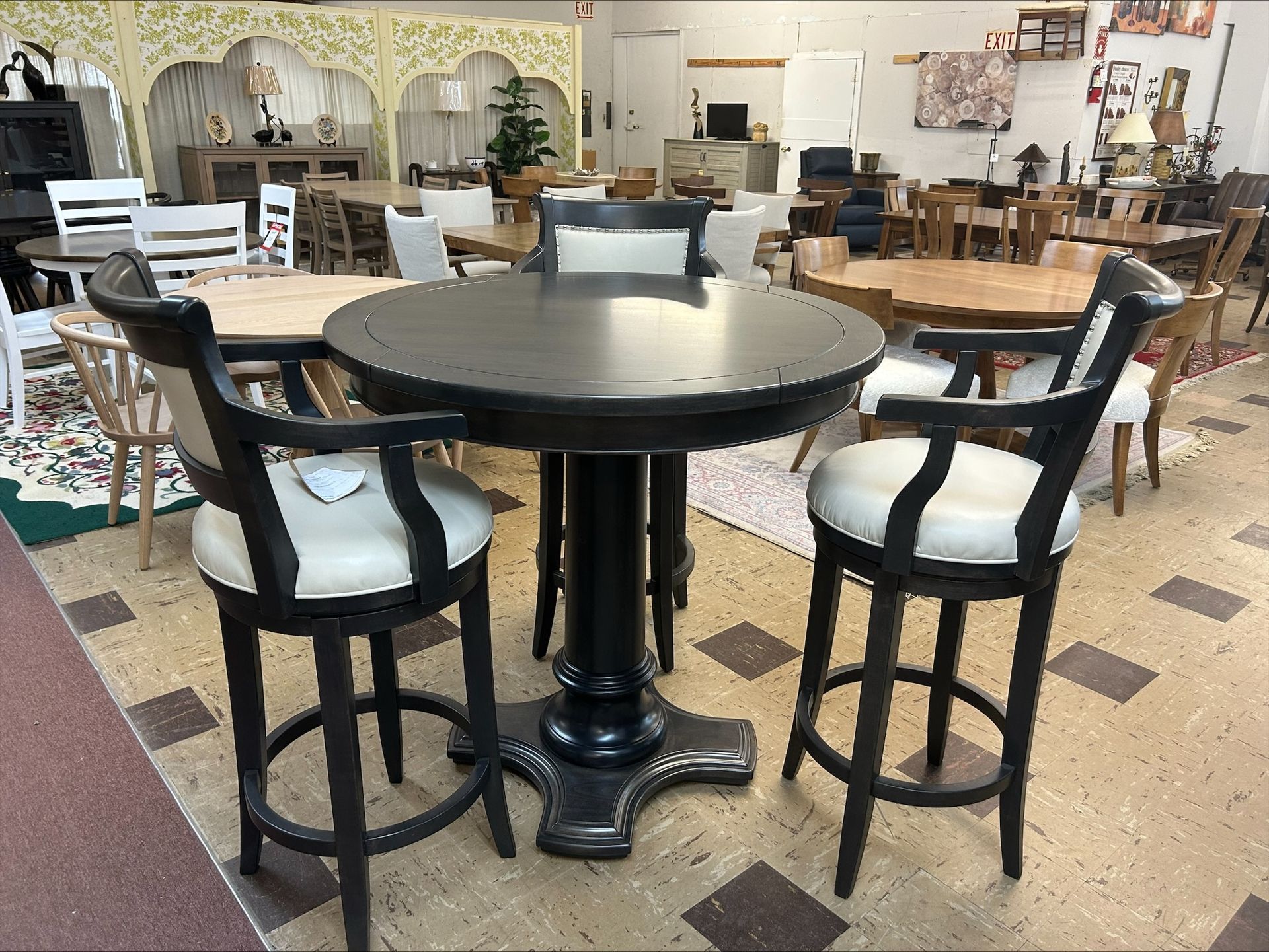Round black table with four chairs in a furniture showroom