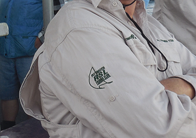 Close-up view of embroidered bowls club logo on a member’s shirt