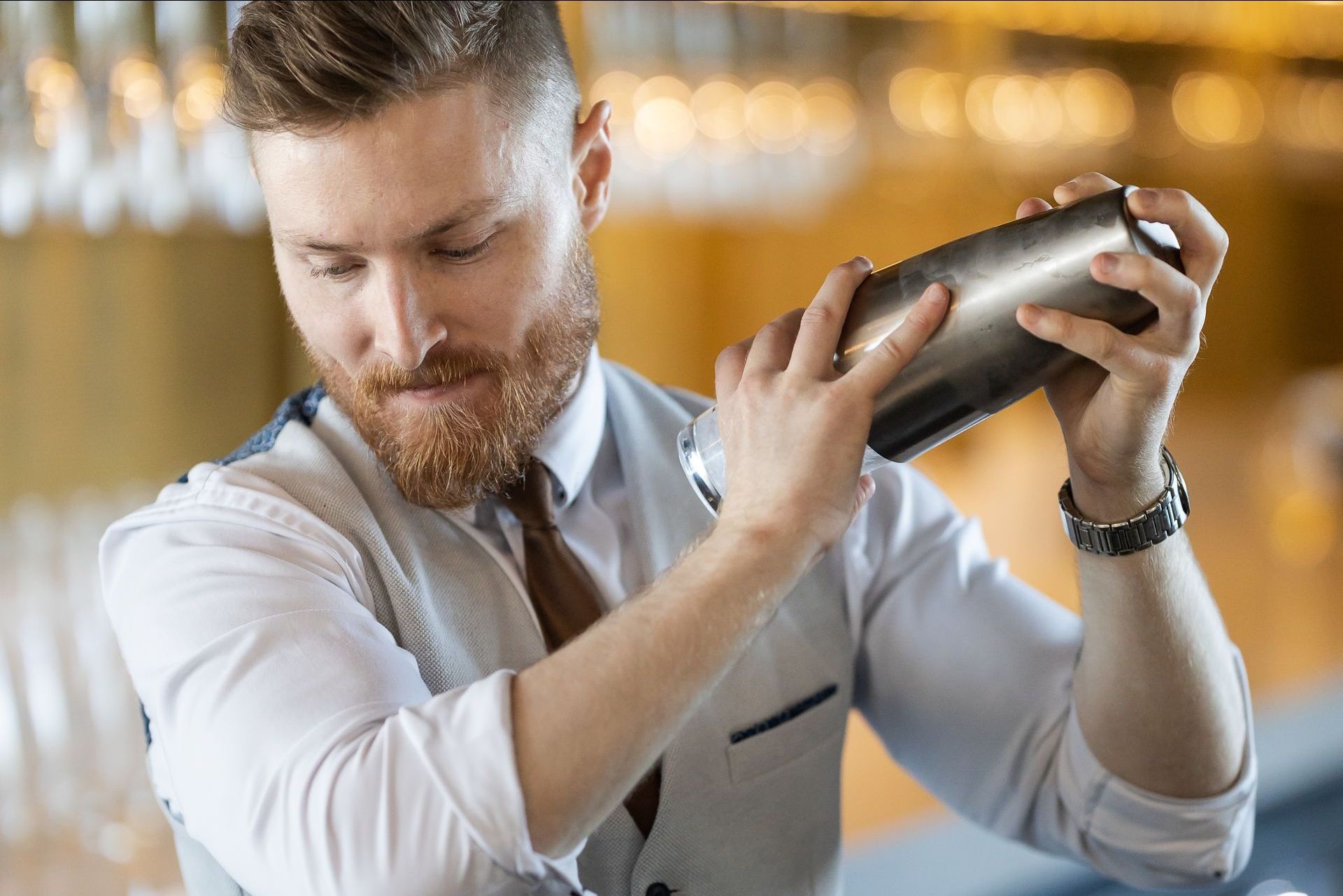 Bartender shaking a cocktail behind the bar at a Pittwater RSL event