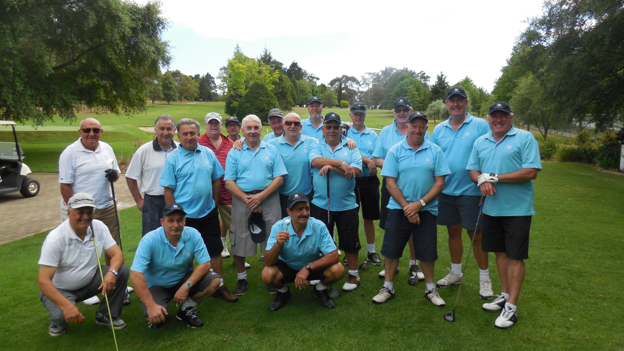 Men’s lawn bowls team posing together on a grassy field at a local club