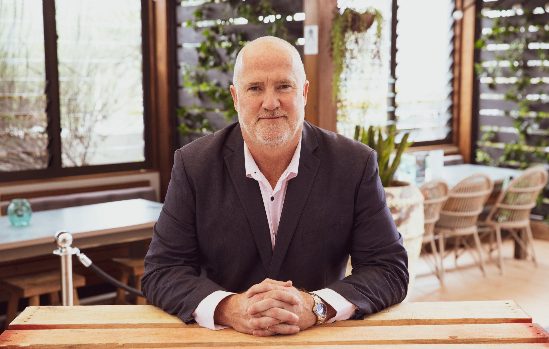 Portrait of Pittwater RSL CEO seated indoors at the club, smiling toward the camera