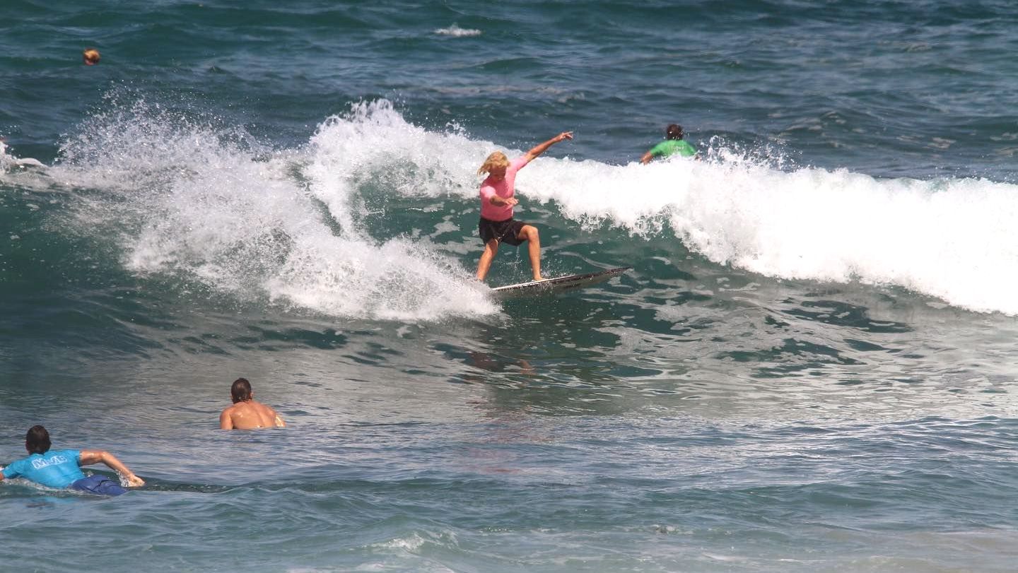 Surfer riding a wave during a Mona Vale Boardriders competition