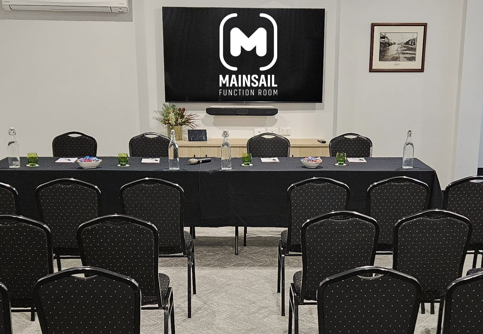 Mainsail function room set up theatre-style with tables and chairs