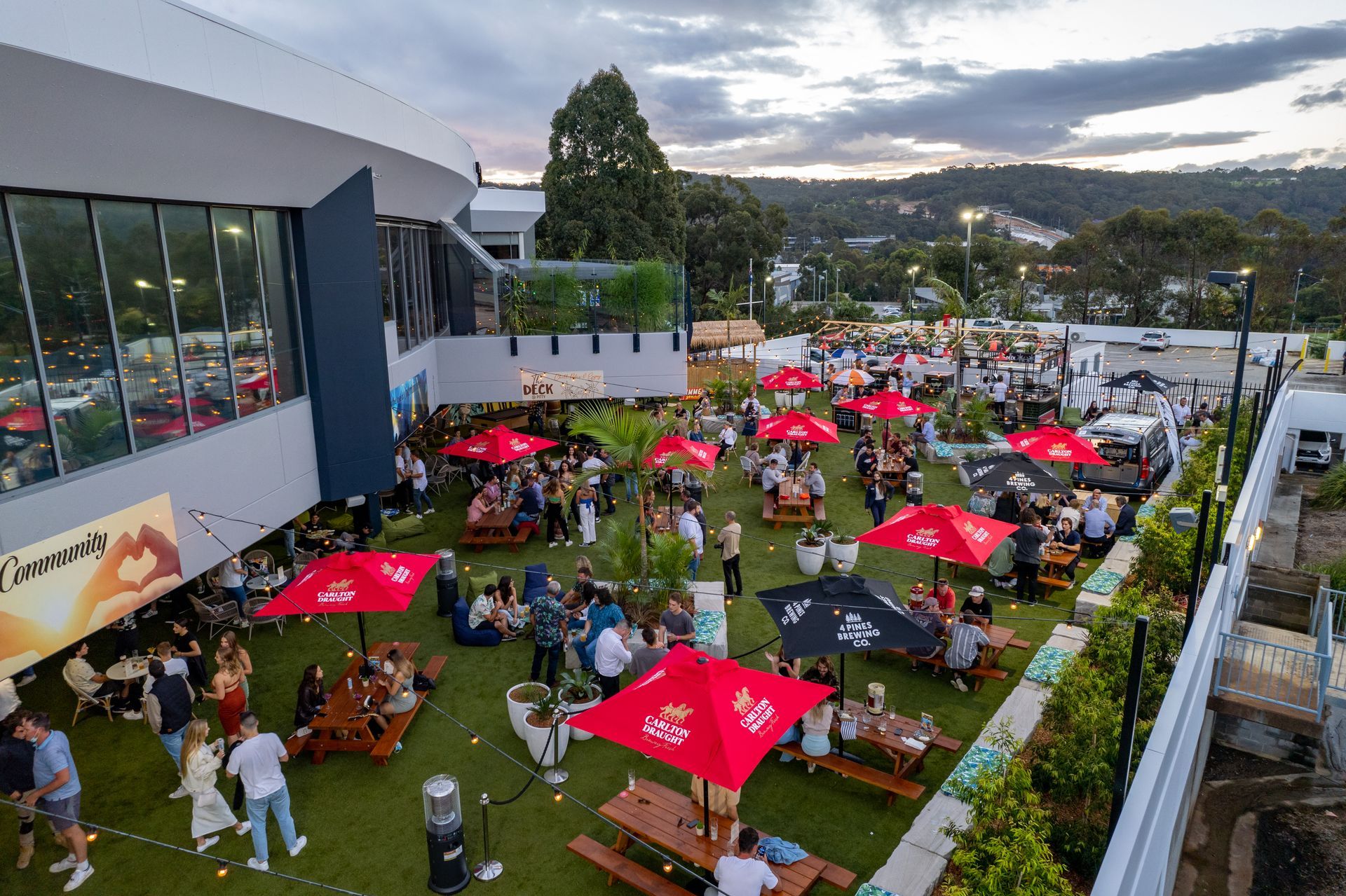 Aerial view of The Deck at Pittwater, showing outdoor dining and entertainment at Mona Vale RSL Club
