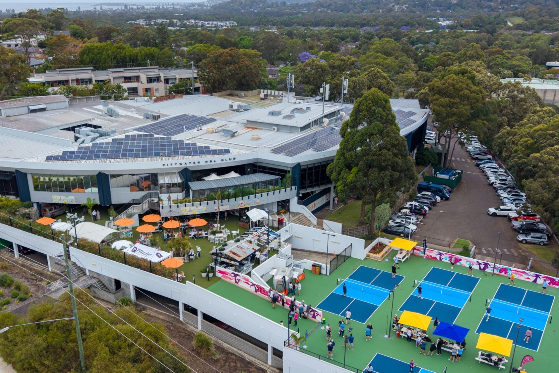 Aerial view of The Deck outdoor event space with umbrellas and guests