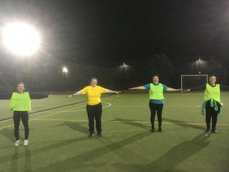 Adults participating in walking football under lights at Pittwater RSL futsal courts