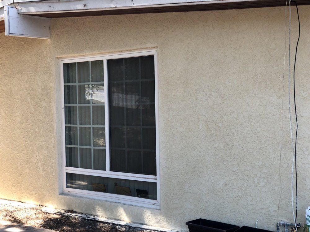A house with a large window on the side of it.