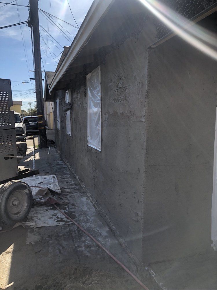 A house is being remodeled with a truck parked in front of it.