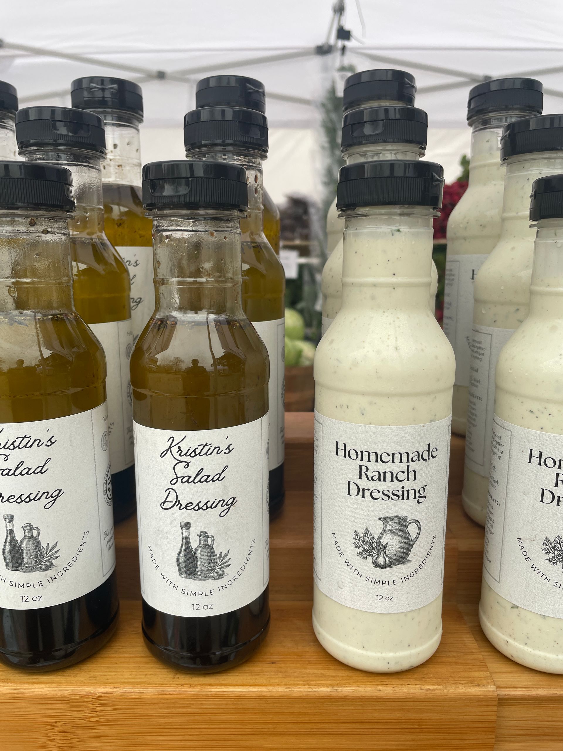 Assorted bottled dairy drinks on a wooden shelf, including pale white and dark brown bottles with labels.