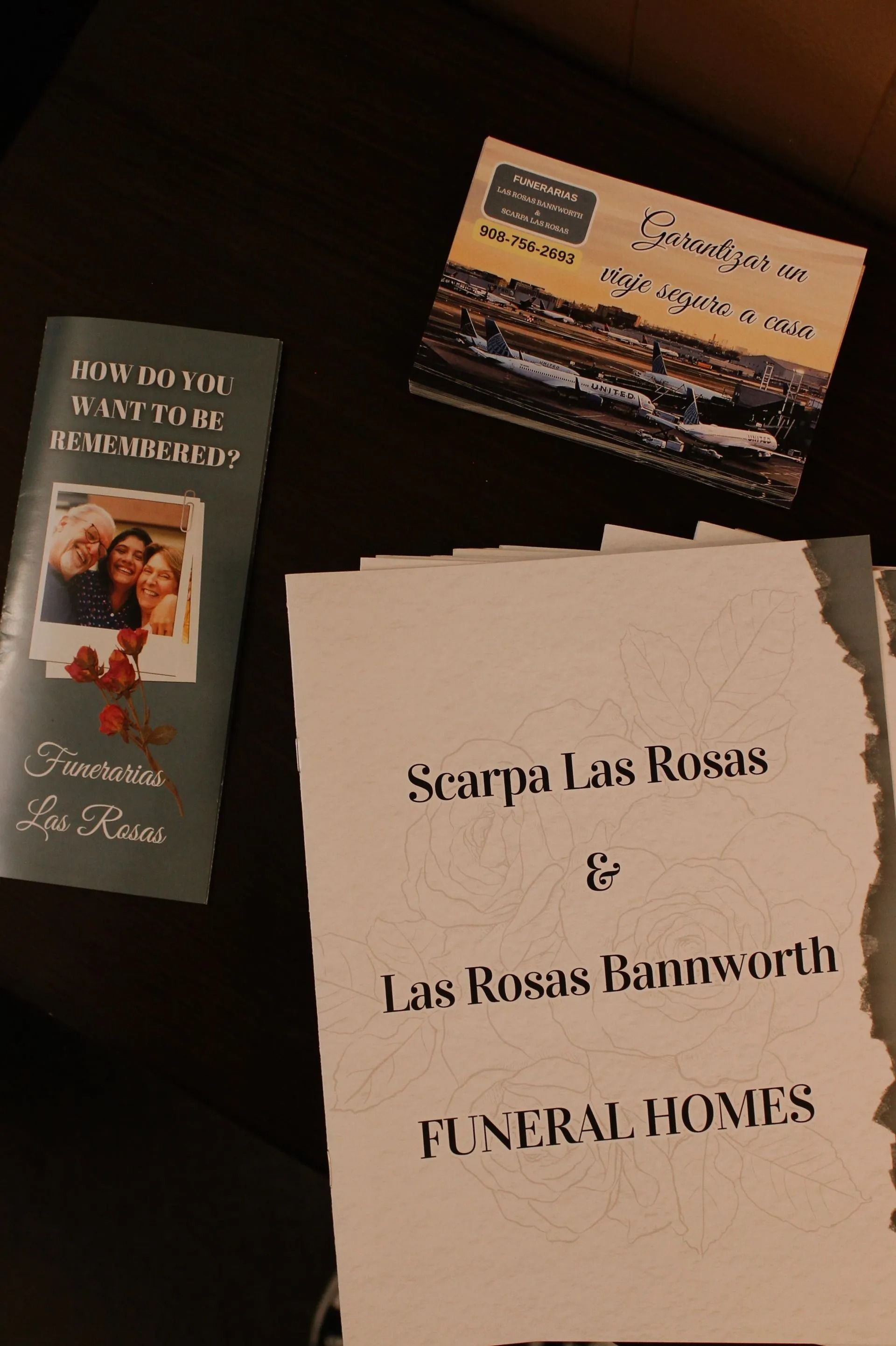 Funeral pamphlets and a business card for