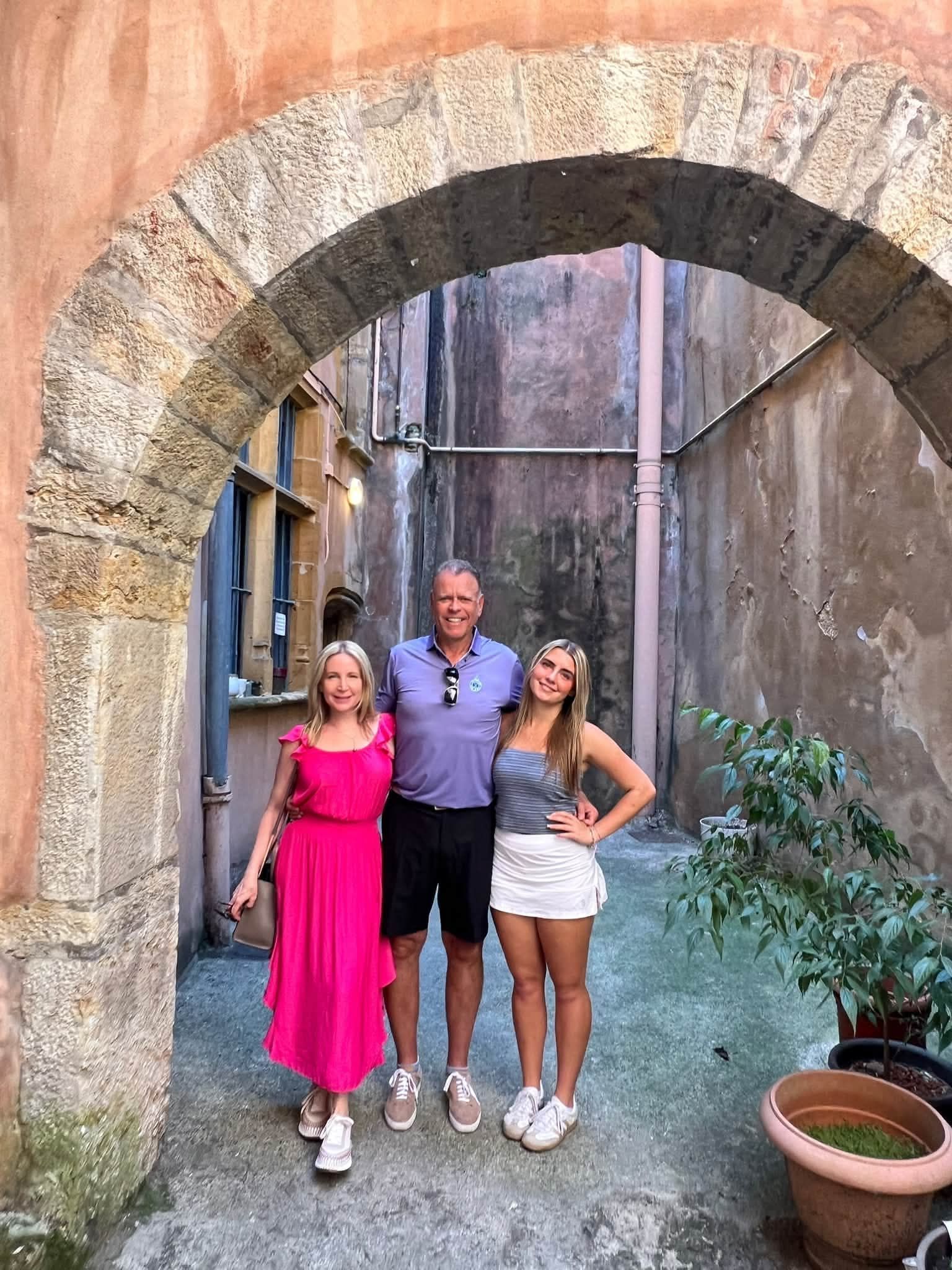 Karen Brown and her family exploring a hidden traboule during a private tour in Lyon.