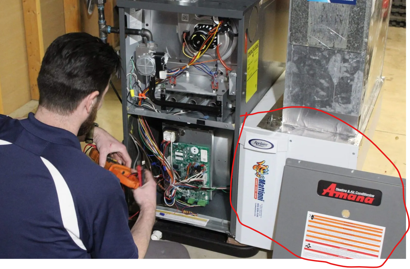 an hvac employee working on commercial furnace maintenance