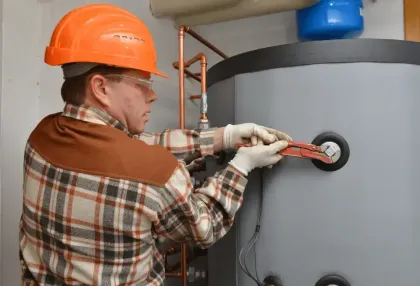 Technician checking boiler controls and piping
