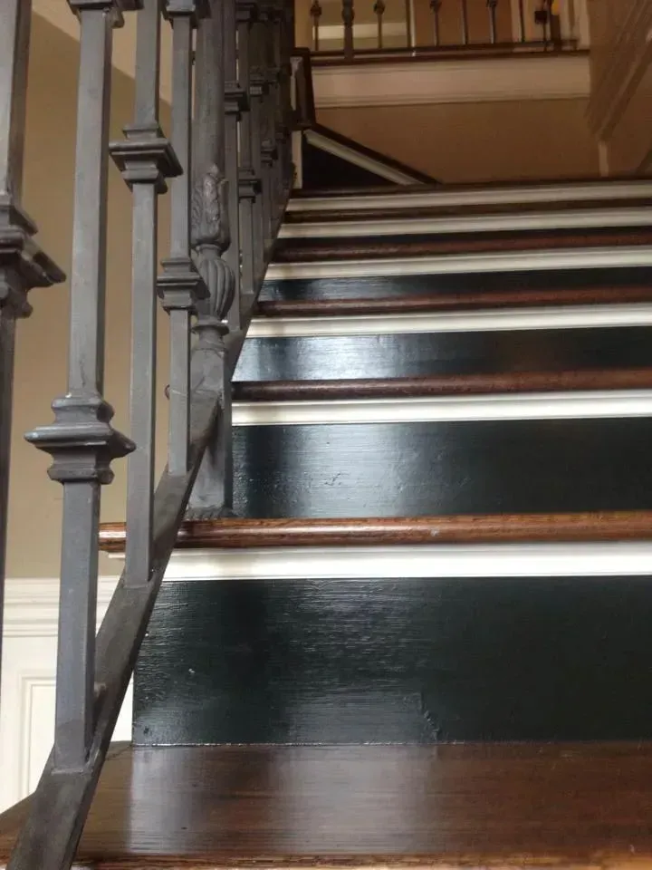 A close up of a set of stairs with a metal railing