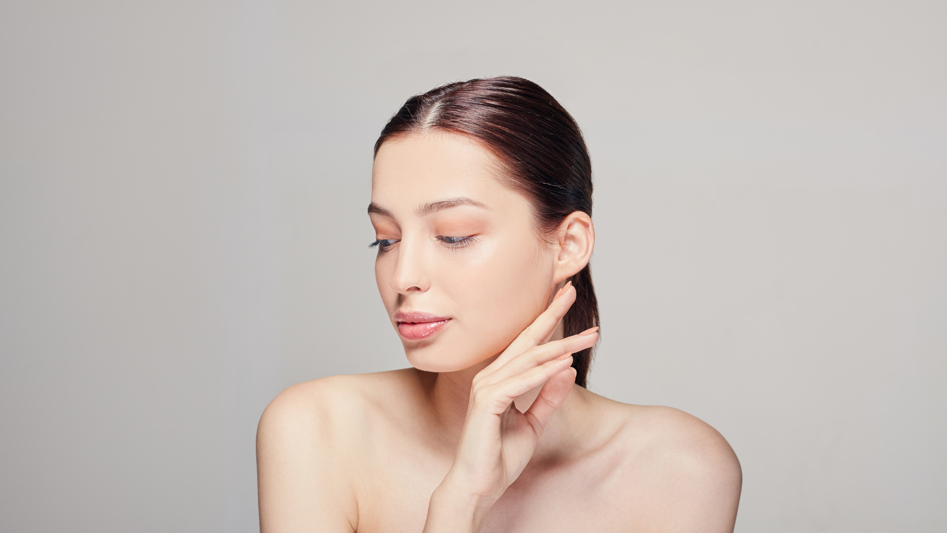 A patient with clear, even skin photographed in soft natural light at MAX MD Medical Aesthetics and Wellness in Garden City, NY