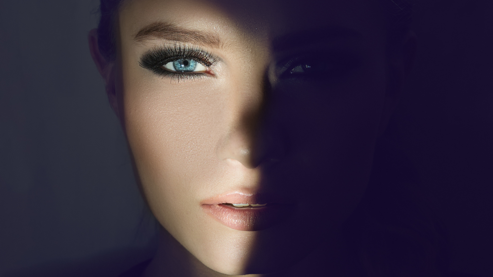 A patient photographed in low light, the eye area lit and in focus at MAX MD Medical Aesthetics and Wellness in Garden City, NY