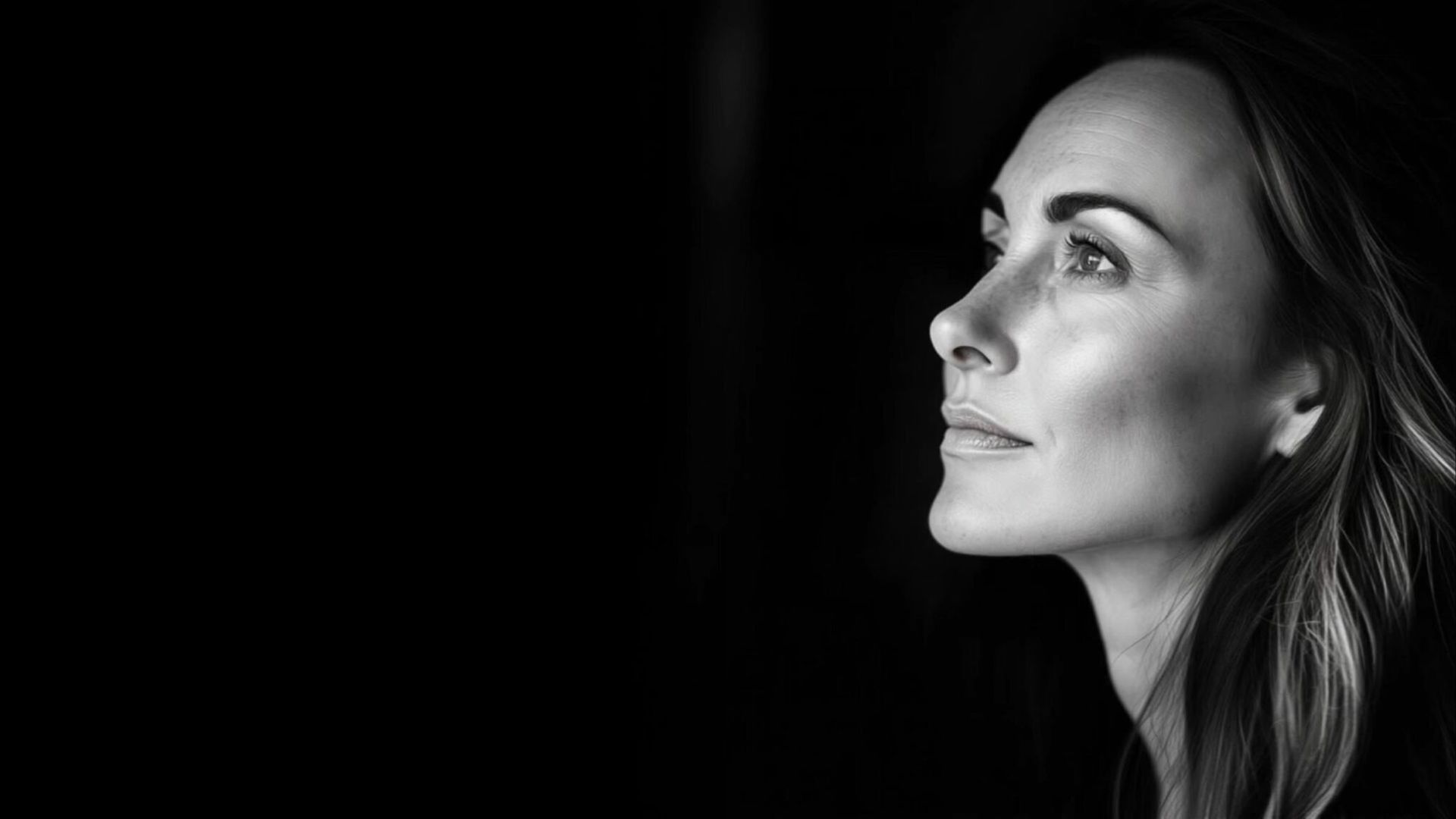 A patient photographed against black, representing ariessence pure PDGF+ rejuvenation at MAX MD in Garden City, NY