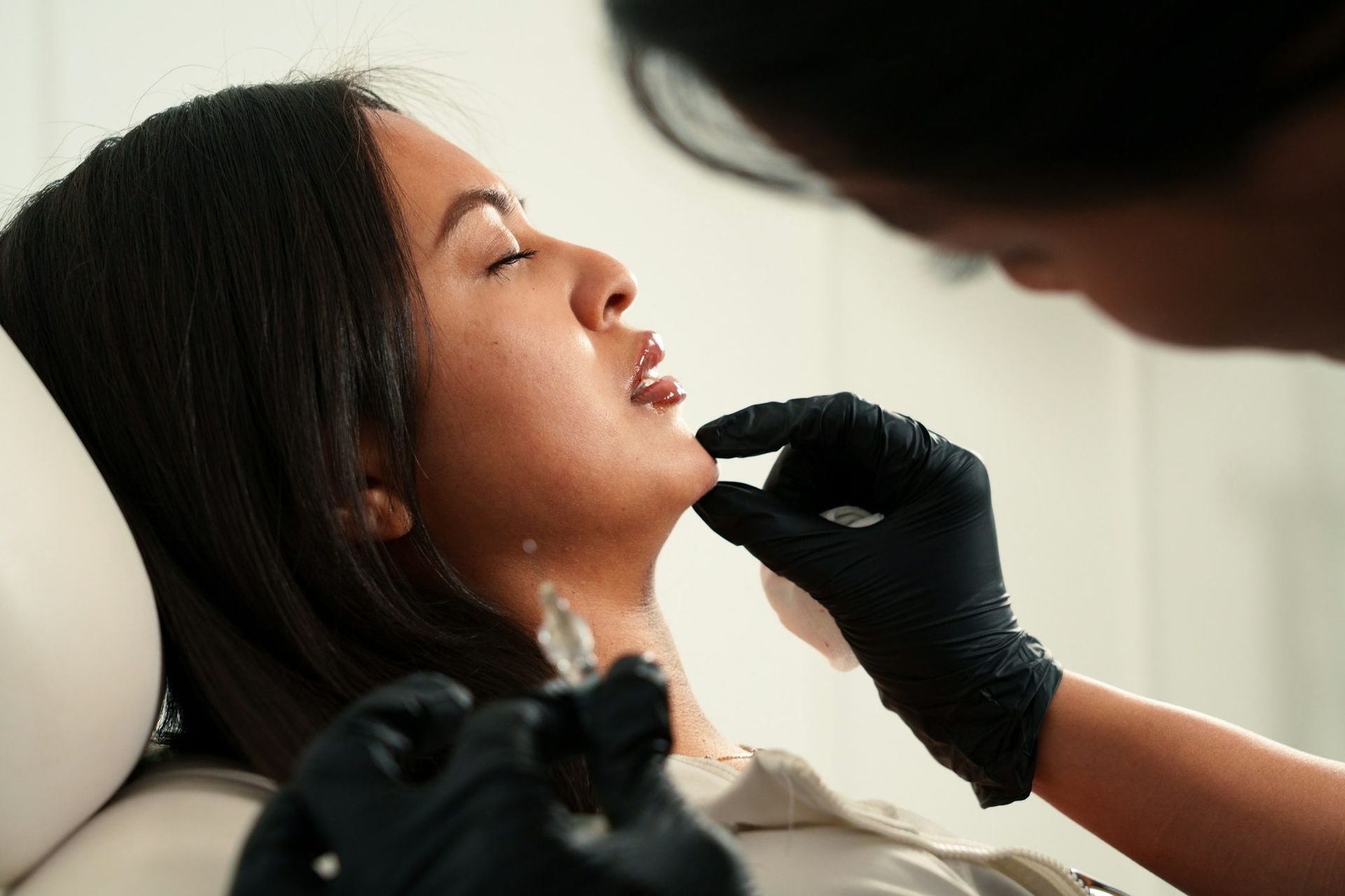 A precise injection placed along the chin by a clinician at MAX MD Medical Aesthetics and Wellness in Garden City, NY