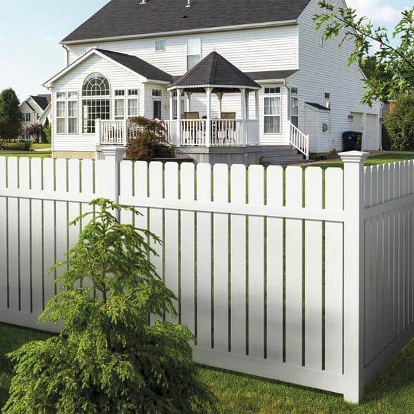 White vinyl fence around a suburban house with a deck and gazebo-style patio enclosure