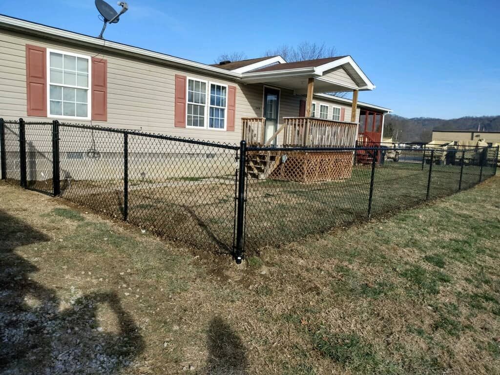 Single-story house with a fenced front yard and small porch on a sunny day