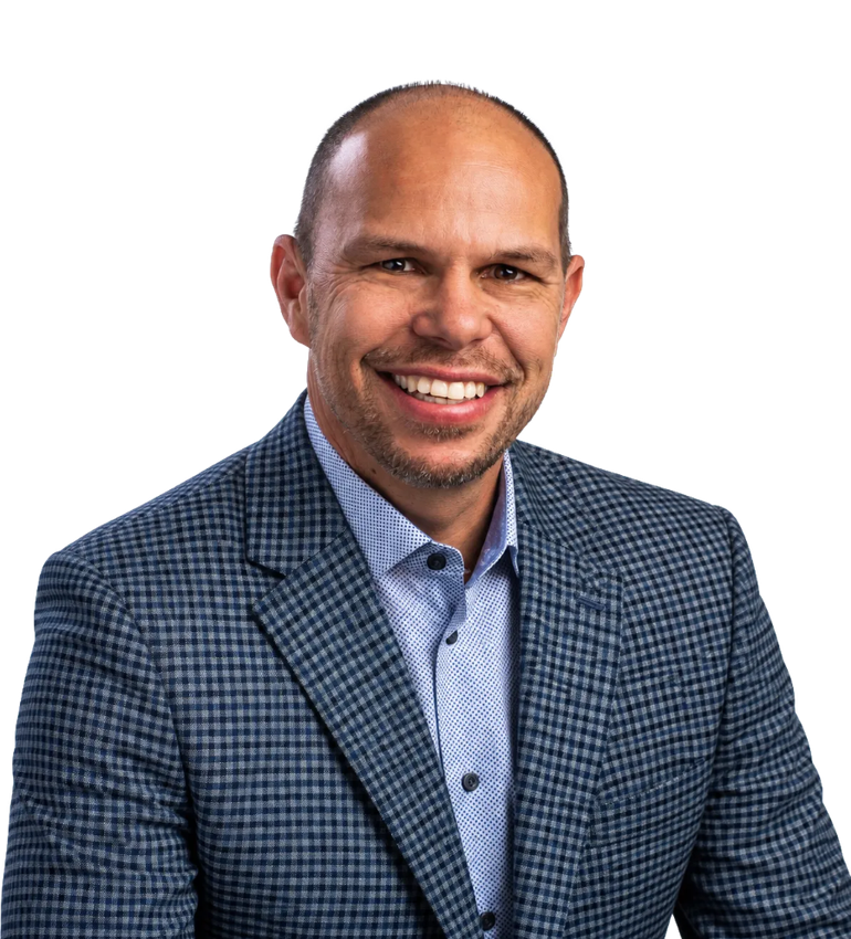 Smiling man in a blue patterned blazer and light blue shirt against a white background
