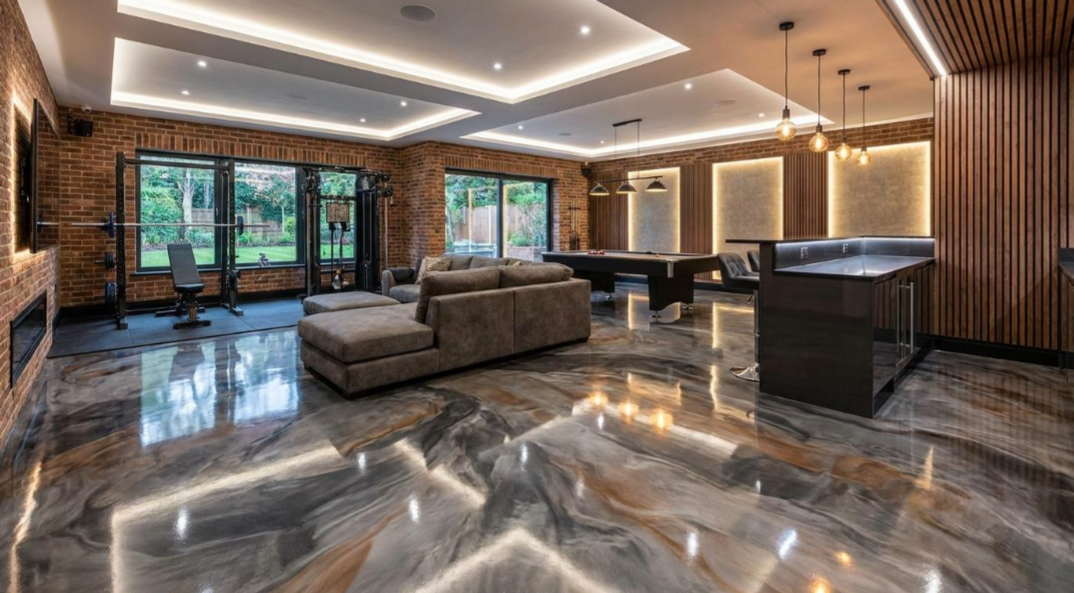 Modern luxury living room with gray sectional, glossy marble floor, recessed lighting, and large windows
