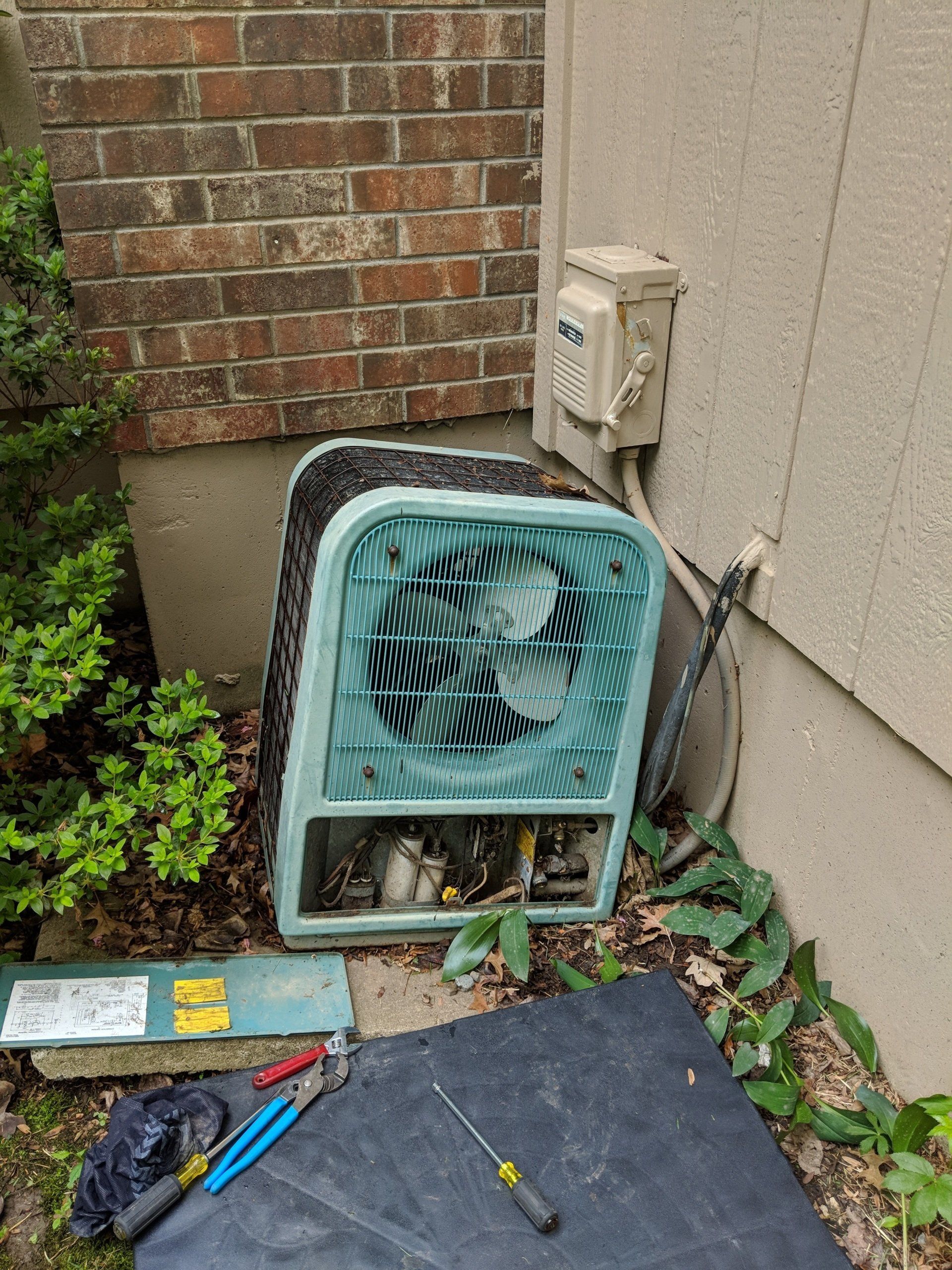 Man Fixing Air Conditioner — Lenexa, KS — Home Comfort Heating And Cooling