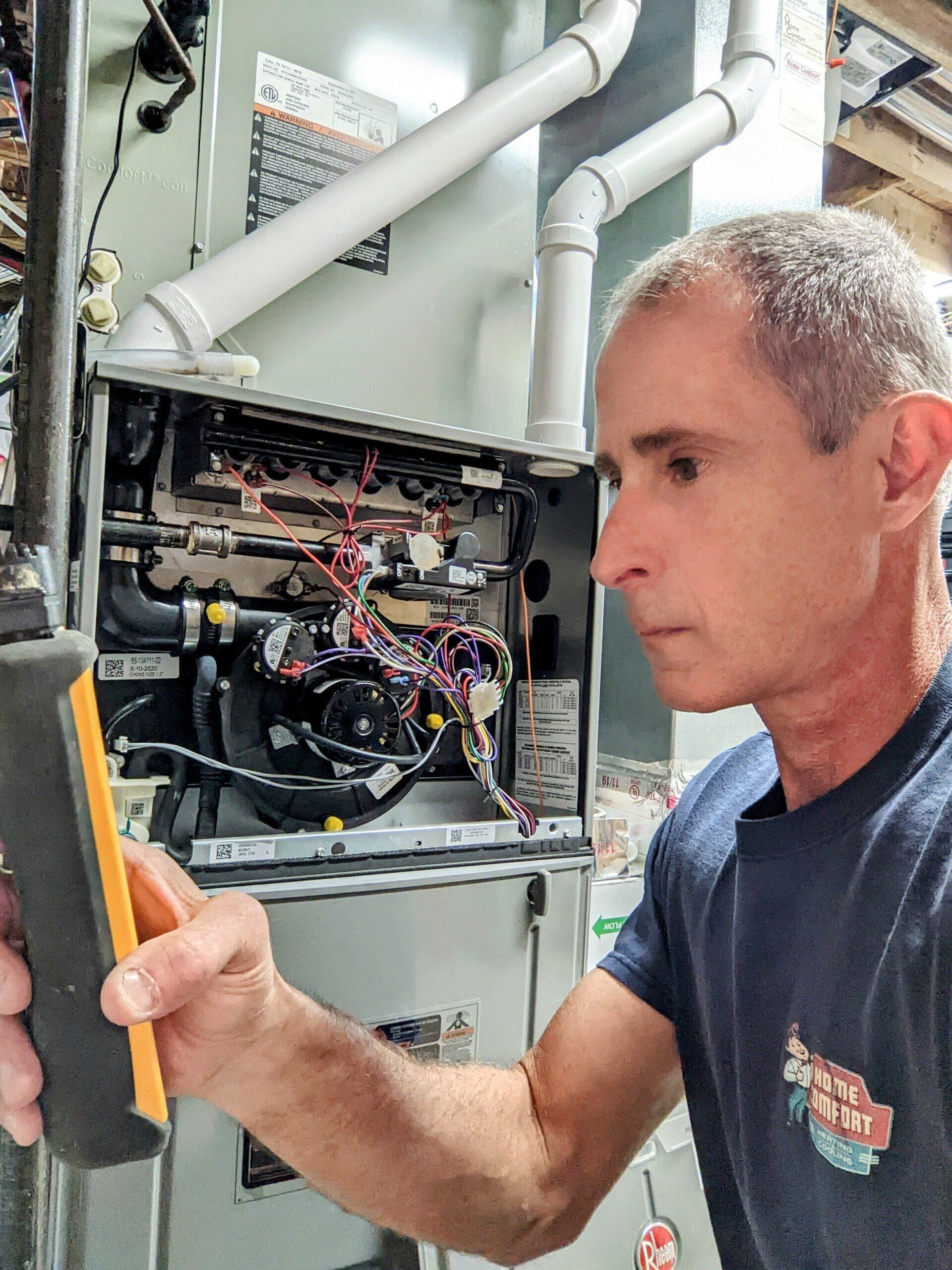 Man Repairing — Lenexa, KS — Home Comfort Heating And Cooling