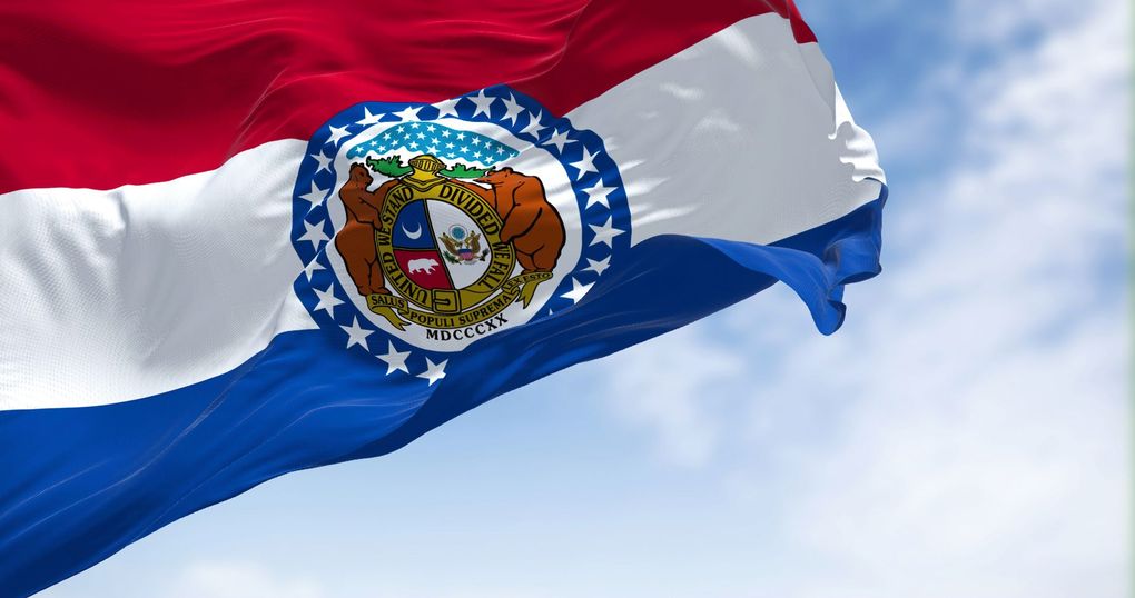 Dominican Republic flag waving against a blue sky