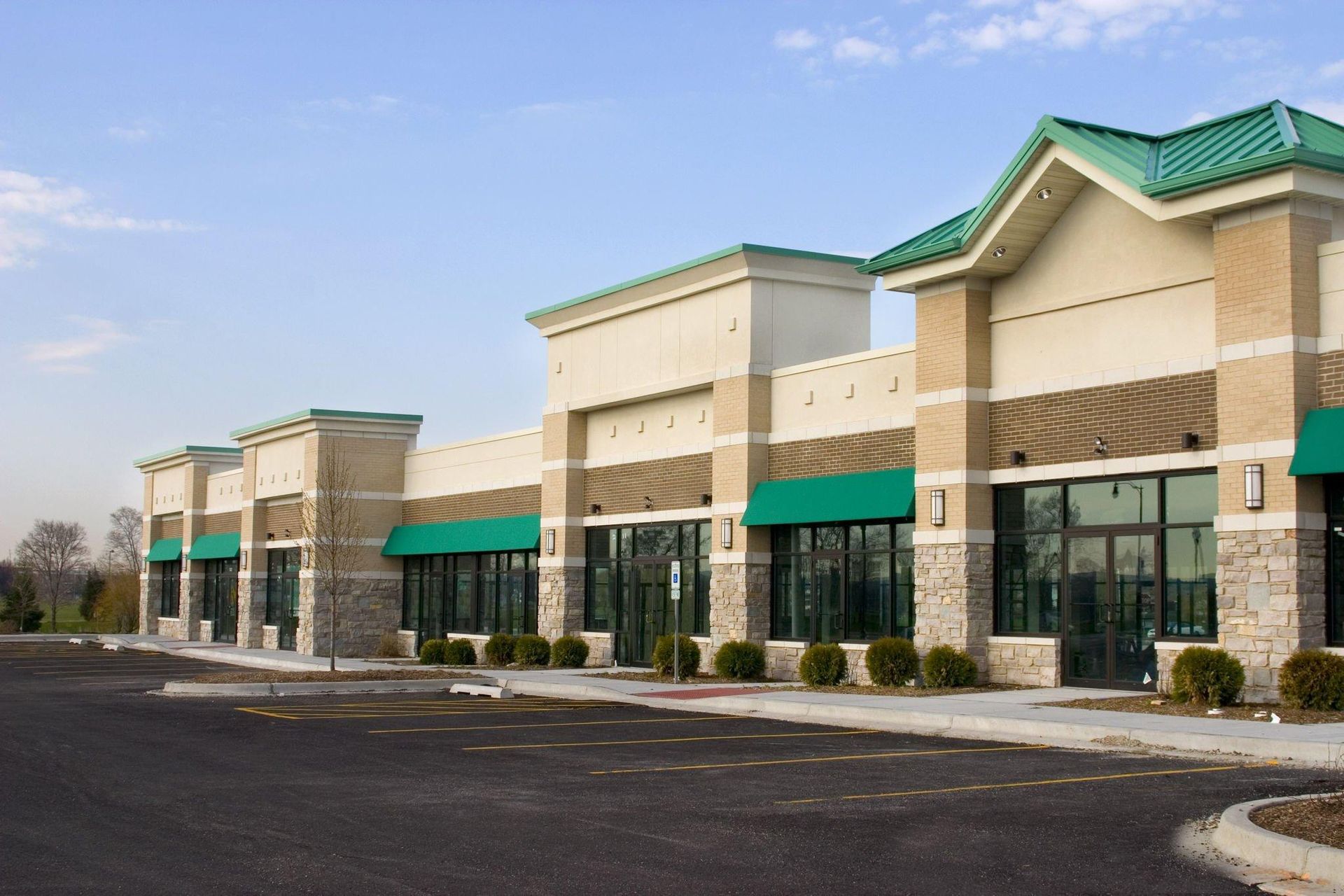 A row of commercial buildings with green awnings