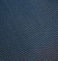 Close-up of a woven dark blue fabric, displaying a repeating textured pattern.
