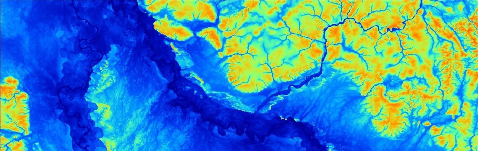 Eine Luftaufnahme einer blau-gelben Landschaft mit einem Fluss.