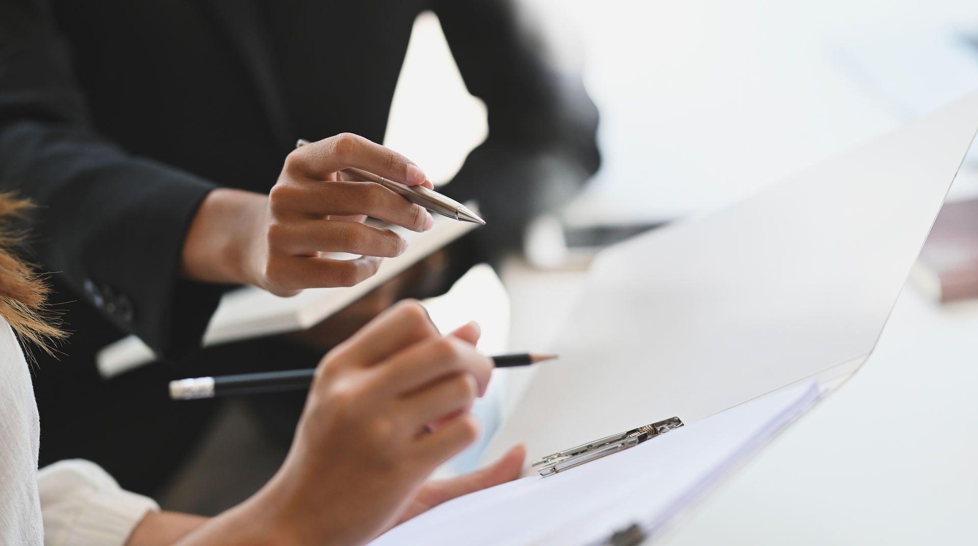A group of people are sitting at a table looking at a piece of paper.