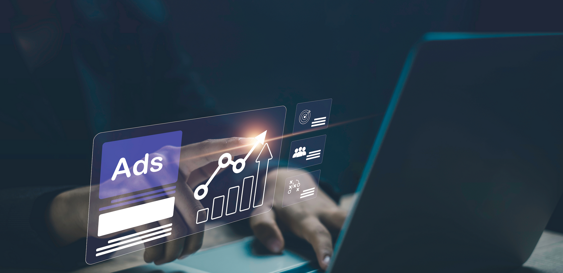 A person is typing on a laptop computer with a graph on the screen.