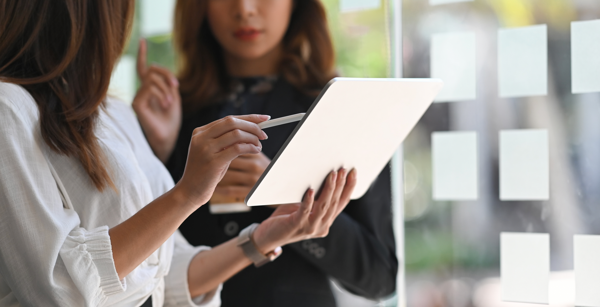 Two women are looking at a piece of paper.