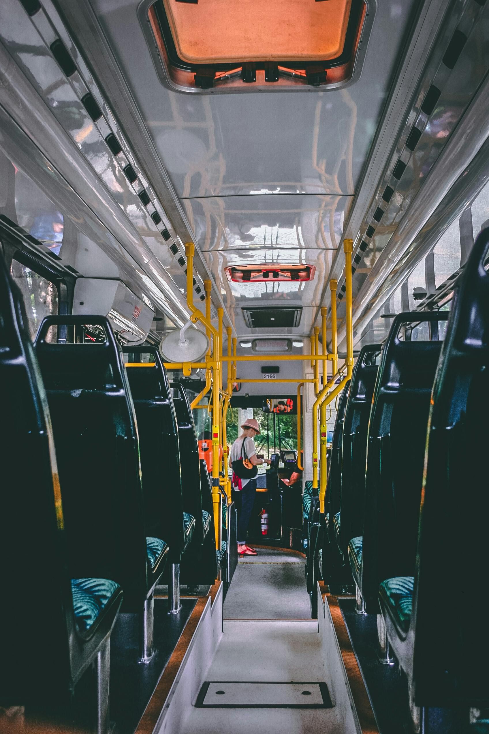 The inside of an empty bus with people sitting on it.