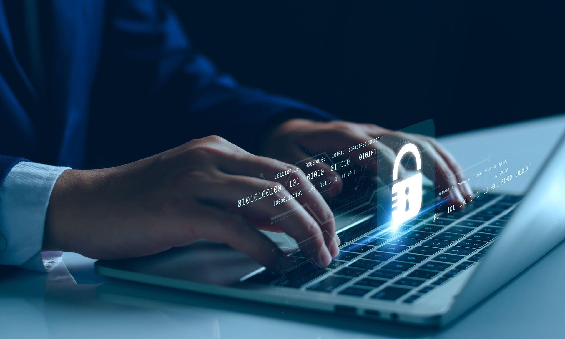A person is typing on a laptop computer with a padlock coming out of the keyboard.