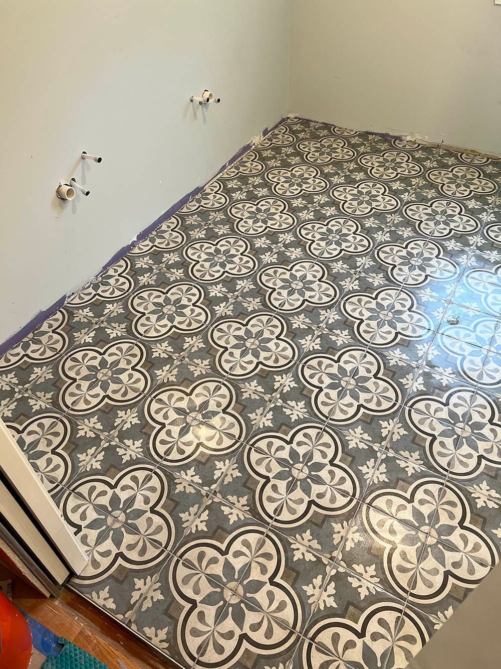 A bathroom floor with a floral pattern on it.