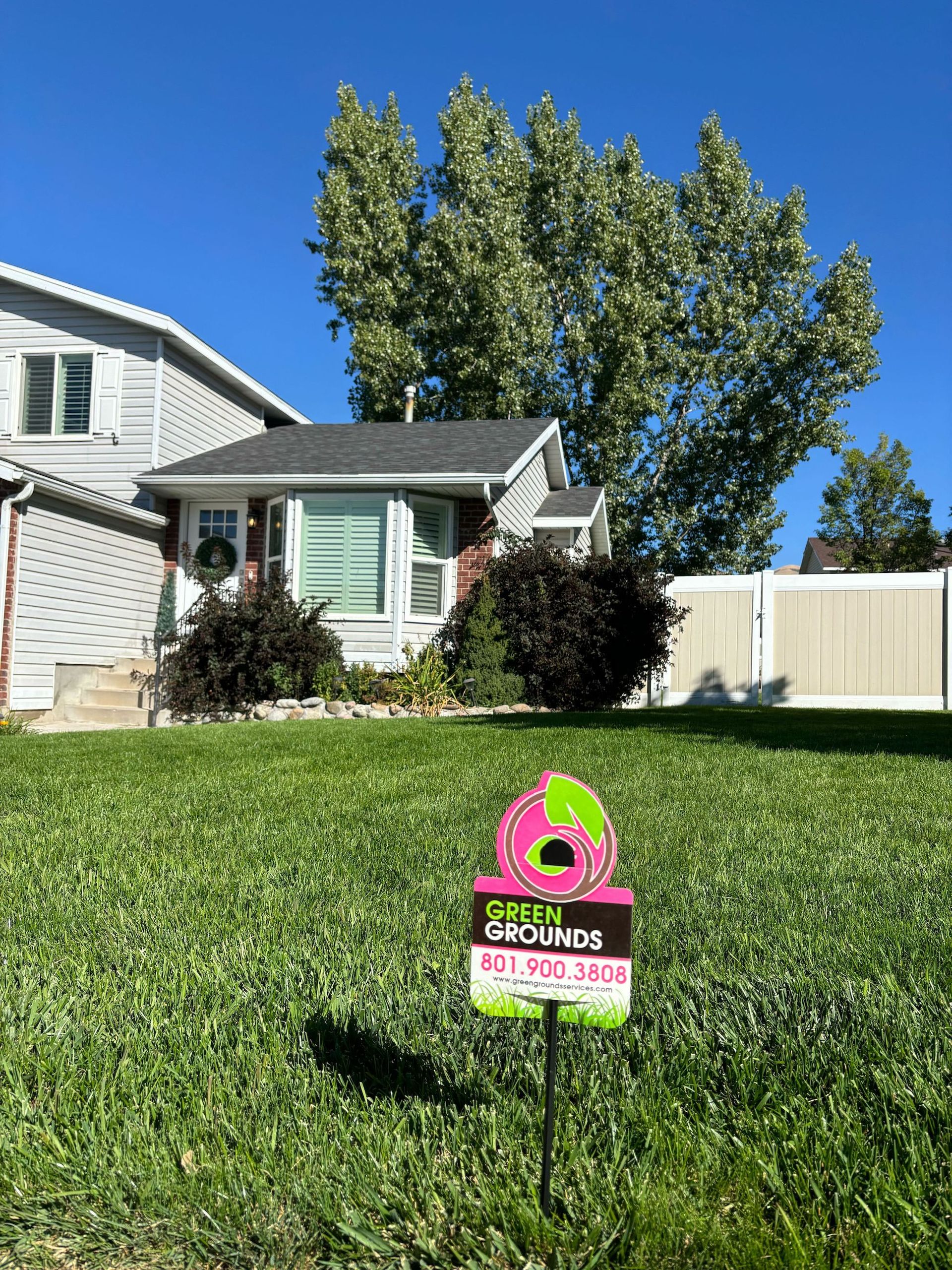 A house with a for sale sign in front of it.