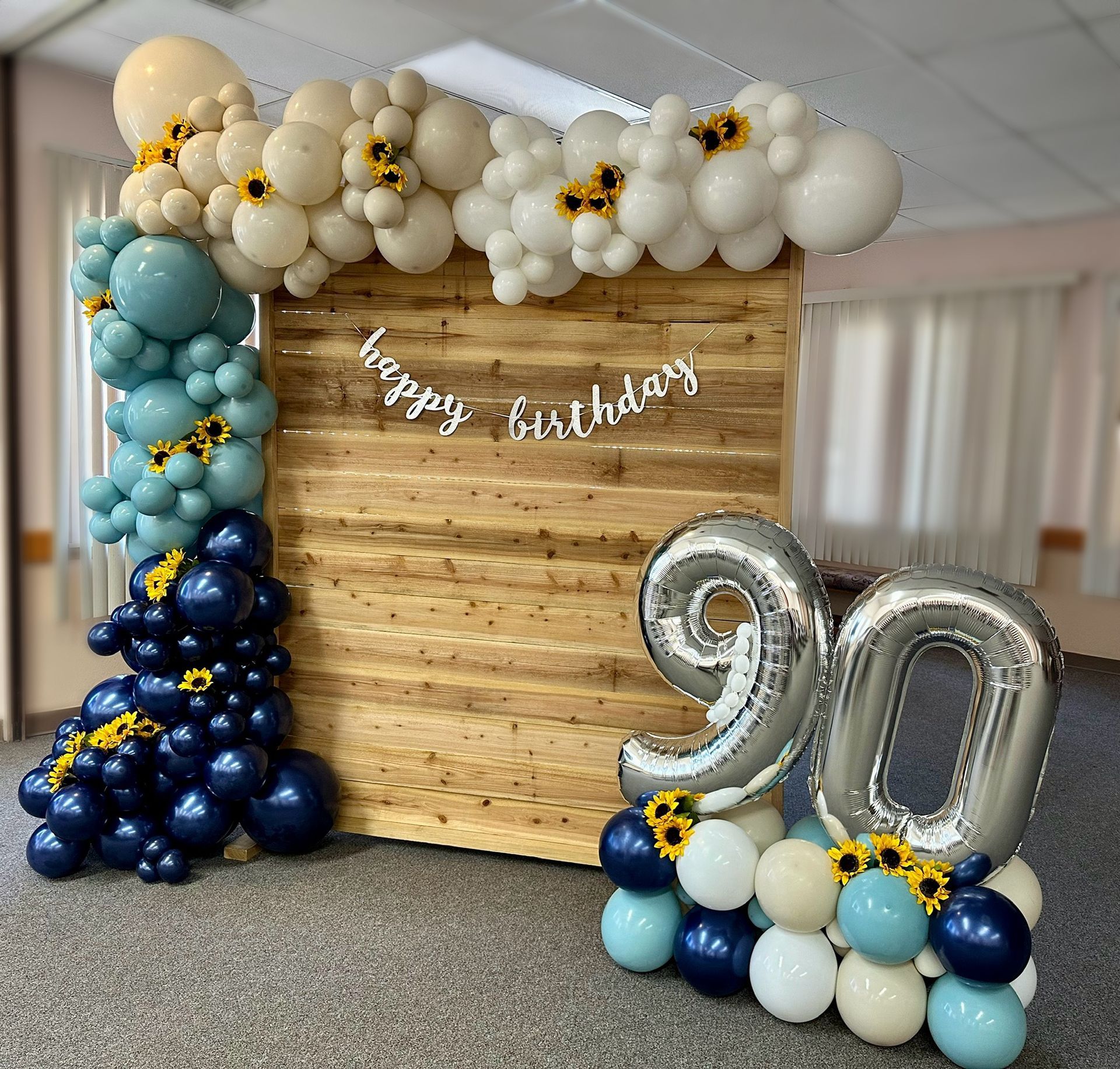 Birthday display: Wooden backdrop with balloon garland and